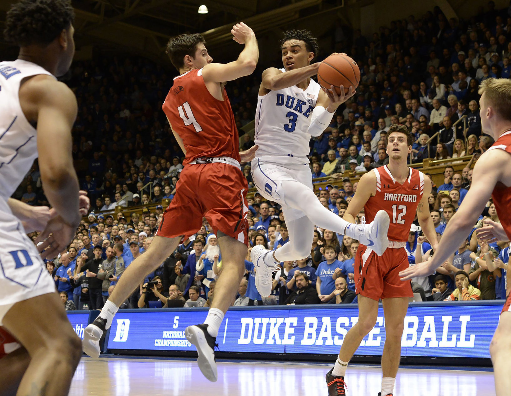 Duke guard Tre Jones (3) looks for help as Hartford forward George Blagojevic (4) defends in the first half at Cameron Indoor Stadium in Durham, N.C., on December 5, 2018.